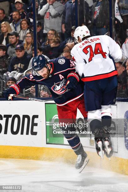 Boone Jenner of the Columbus Blue Jackets collides with John Carlson of the Washington Capitals against the boards during the third period in Game...