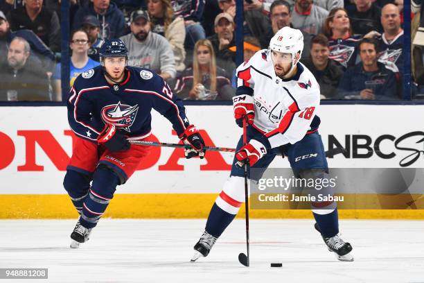 Chandler Stephenson of the Washington Capitals skates the puck away from Ryan Murray of the Columbus Blue Jackets during the third period in Game...