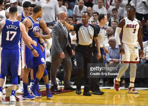 Referee James Capers gets in between Justin Anderson of the Philadelphia 76ers and Dwyane Wade of the Miami Heat after a flagrant foul during the...