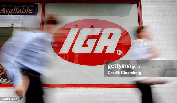 Pedestrians walk past an IGA supermarket in Sydney, Australia, on Tuesday, June 3, 2008. Metcash Ltd., Australia's largest grocery wholesaler,...