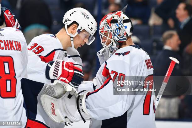 Alex Chiasson of the Washington Capitals celebrates with goaltender Braden Holtby of the Washington Capitals after defeating the Columbus Blue...