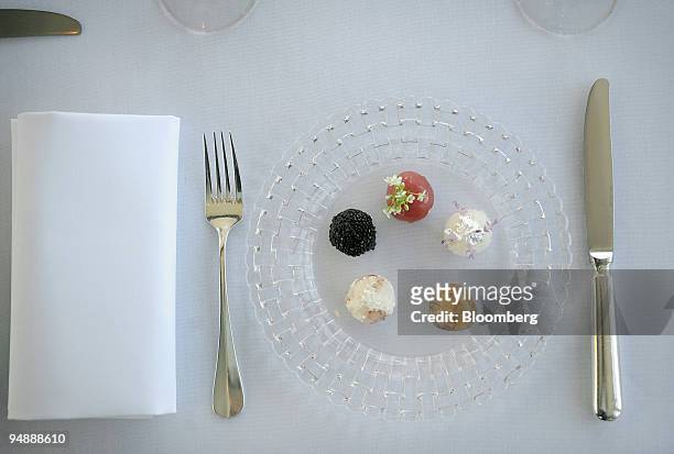 The signature "Sea Pearls" dish of sashimi tuna, smoked eel, octopus, egg white pearls, sea scallop, and tapioca is arranged for a photograph at the...
