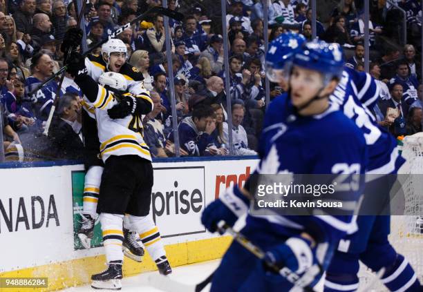 Jake DeBrusk of the Boston Bruins celebrates his goal on the Toronto Maple Leafs with teammate David Krejci in Game Four of the Eastern Conference...