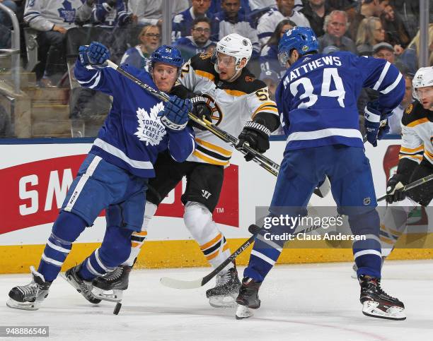 Sean Kuraly of the Boston Bruins battles against Jake Gardiner of the Toronto Maple Leafs in Game Four of the Eastern Conference First Round in the...