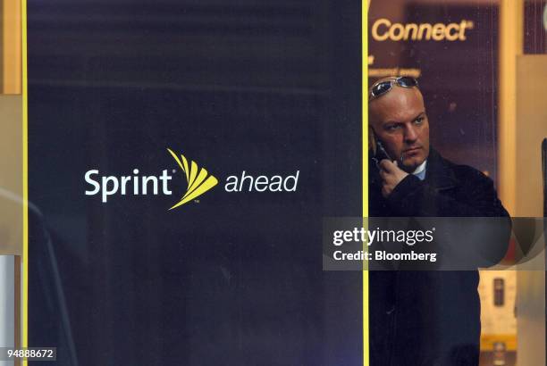 Man talks on a mobile phone inside a Sprint retail store in New York, U.S. On Thursday, Feb. 28, 2008. Sprint Nextel Corp. Rose as much as 8.4...