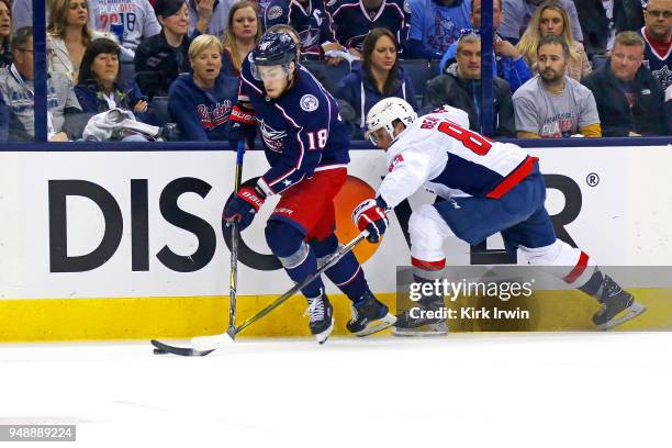 Pierre-Luc Dubois of the Columbus Blue Jackets skates the puck against Jay Beagle of the Washington Capitals during the third period in Game Four of...