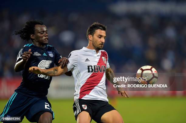 Argentina's River Plate player Ignacio Scocco vies for the ball with Ecuador's Emelec player Juan Paredes, during their Copa Libertadores football...