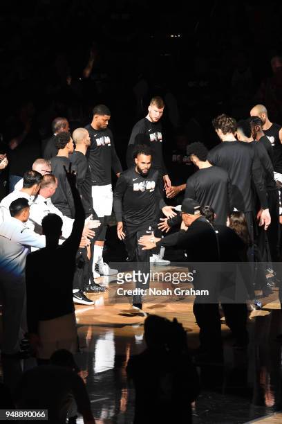 Patty Mills of the San Antonio Spurs high fives his teammates before the game against the Golden State Warriors in Game Three of Round One of the...