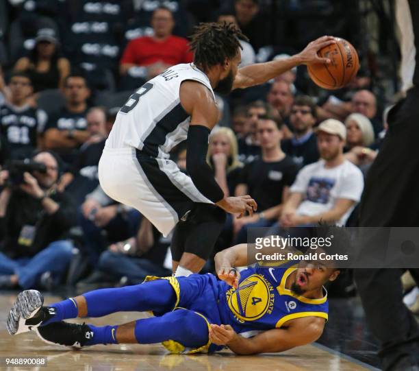 Quinn Cook of the Golden State Warriors hits the floor after being fouled by Patty Mills of the San Antonio Spurs chasing a loose ball at AT&T Center...