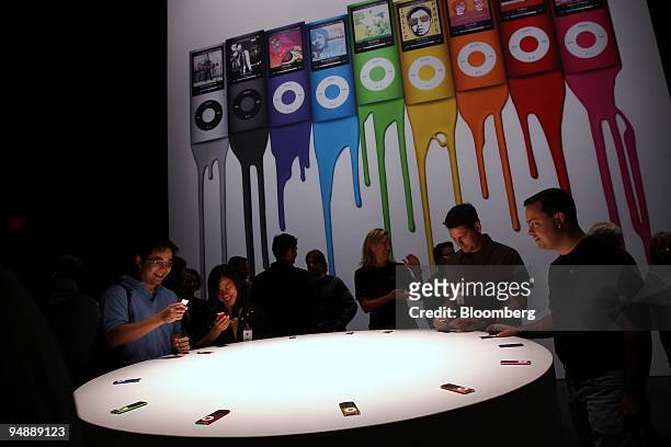 Attendees test out new Apple Inc. IPod Nano media players during an event titled "Let's Rock" at the Yerba Buena Center for the Arts Theater in San...