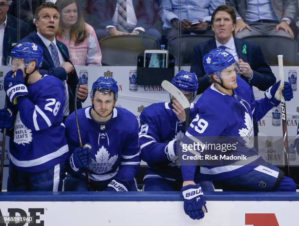 Assistant coach Jim Hiller and Head coach Mike Babcock look at the scoreboard as time expires. Front row, Toronto Maple Leafs right wing Connor Brown...