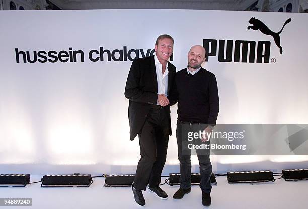 Jochen Zeitz, left, chief executive officer of Puma AG, left, shakes hands with Hussein Chalayan, British-based Cypriot fashion designer, during a...