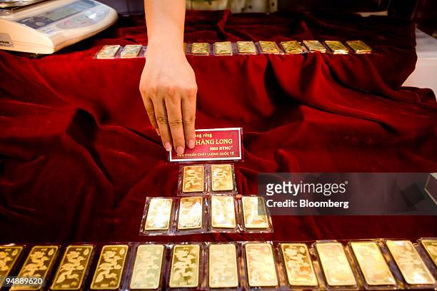Clerk at a gold store arranges gold bars in Hanoi, Vietnam, on Monday, Sept. 8, 2008. Vietnam Export-Import Commercial Joint-Stock Bank started a...