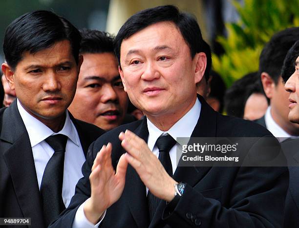 Thaksin Shinawatra, former prime minister of Thailand and owner of the Manchester City football club, acknowledges a crowd as he arrives at the...