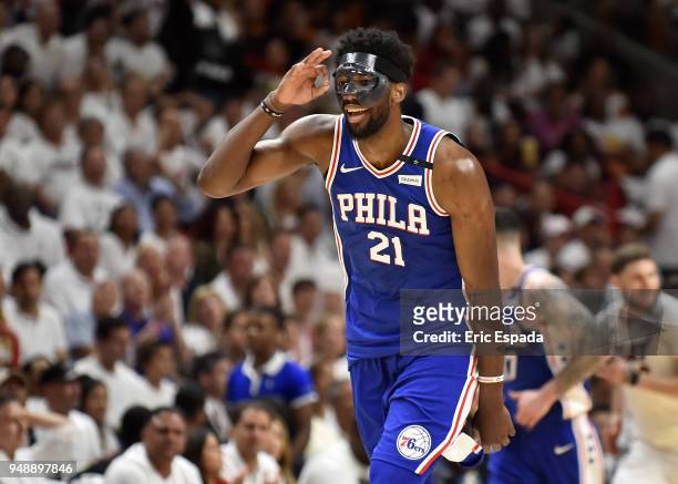 Joel Embiid of the Philadelphia 76ers reacts after hitting a three pointer in the third quarter against the Miami Heat at American Airlines Arena on...