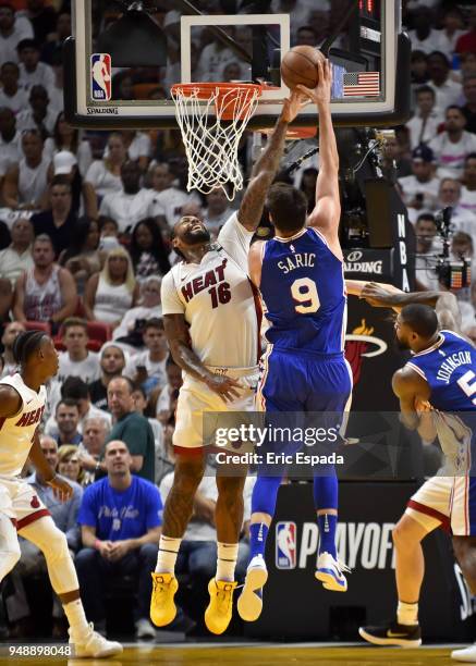 James Johnson of the Miami Heat blocks a shot by Dario Saric of the Philadelphia 76ers during the third quarter of the game at American Airlines...