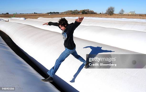 Boy jumps over bags containing soybeans that farmers refuse to sell near Pergamino, Argentina, on Thursday, May 29, 2008. Argentina's farmers have...