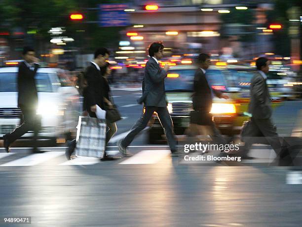 People cross an intersection in Tokyo, Japan, on Wednesday, May 28, 2008. Japan's unemployment rate was unchanged in May as higher energy costs...