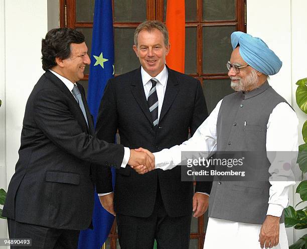 Indian Prime Minister Manmohan Singh, right, shakes hands with visiting European Commission President Jose Manuel Barroso, left, while British Prime...