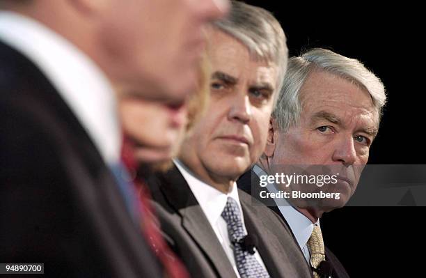 Charles Schwab, right, listens during the announcement of 'Schwab Personal Choice' in New York on February 10, 2004. Pictured second from right is...