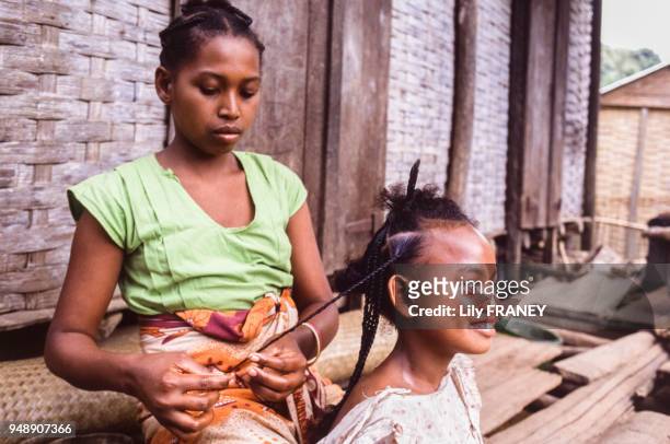 Jeunes filles se faisant des tresses à Antalaha, en 1988, Madagascar.