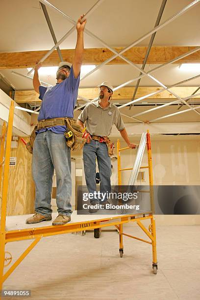 Apprentice Antonio Veltran, left, works on installing a ceiling as instructor Scott Payne observes at the Southern California Carpentry training...