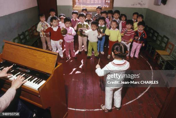 Enfants d'une crèche lors d'une activité musicale à Shanghai, en mai 1987, Chine.