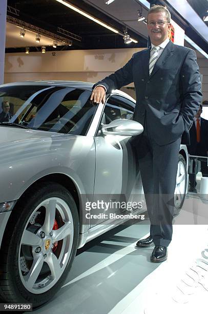 Porsche Chief Executive Dr. Wendelin Wiedeking poses with a Porsche Cayman S automobile at the IAA Frankfurt Car Show in Frankfurt, Germany, Tuesday,...