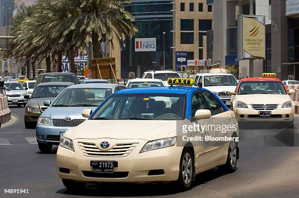 Taxis drive down Bank Street in Dubai, United Arab Emirates, on Thursday, May 22, 2008. About 6,000 taxis and 500 buses serve more than six million...