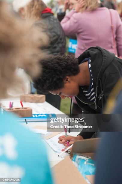 Gini Ziegler of Littleton signs up for information before a rally and vigil at Columbine High School on April 19, 2018 in Littleton, Colorado. April...