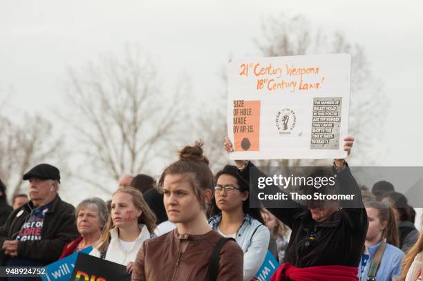 Terri Straut of Littleton becomes emotional during the Vote For Our Lives rally and vigil at Columbine High School on April 19, 2018 in Littleton,...