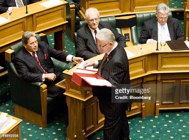 Michael Cullen, New Zealand's finance minister, center, presents a copy of the budget to Winston Peters, New Zealand's foreign minister, left, prior...