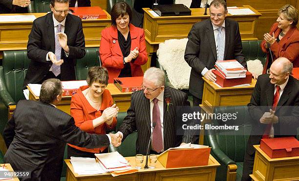 Michael Cullen, New Zealand's finance minister, center, shakes hands with Jim Anderton, New Zealand's minister of agriculture, as Helen Clark, New...