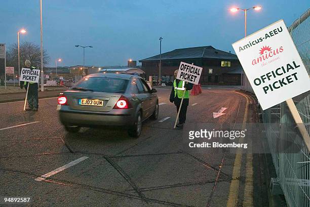 Motorist is stopped by members of the Transport and General Workers Union and Amicus unions during a picket at the main entrance to the Land Rover...