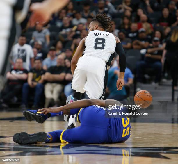 Kevin Durant of the Golden State Warriors grabs his ankle after Patty Mills of the San Antonio Spurs stole the ball from him at AT&T Center on April...