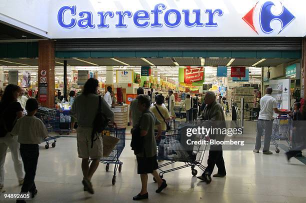 Shoppers outside a Carrefour store in Bercy near Paris, France, Tuesday, August 31, 2004. Shares of Carrefour SA, the world's second-largest...