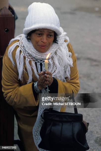 Croyante à genoux portant une bougie en mai 1982, à Fatima, Portugal.