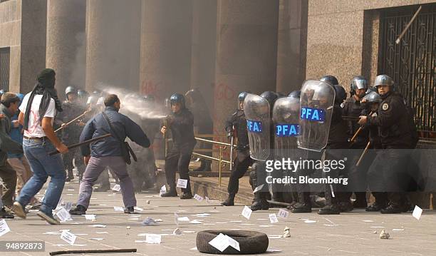 Police clash with demonstrators at the entrance of the Finance Ministry where International Monetary Fund Director Rodrigo de Rato was meeting with...
