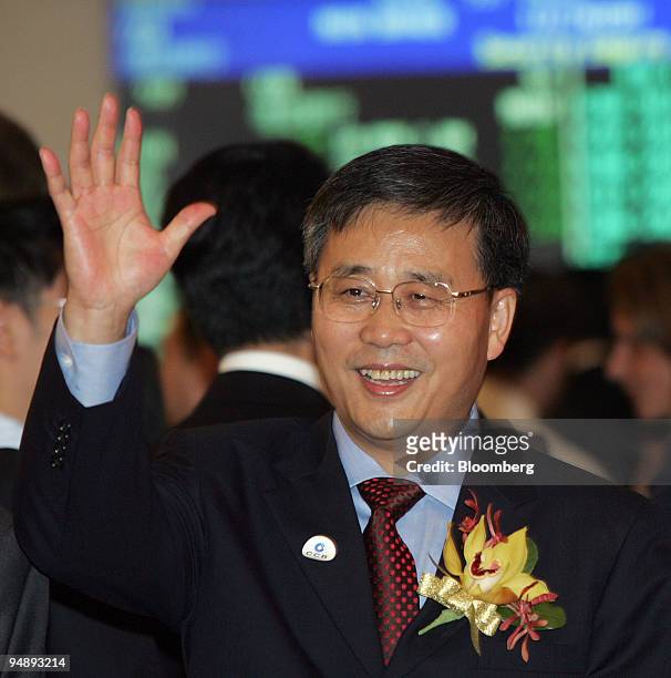 China Construction Bank Corp. Chairman Guo Shuqing waves to photographers Thursday, October 27, 2005 at the Hong Kong Stock Exchange where shares in...