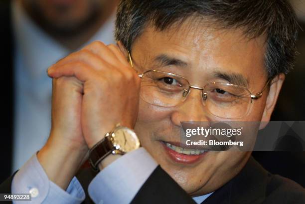 China Construction Bank Corp. Chairman Guo Shuqing gestures to reporters at the trading debut Thursday, October 27, 2005 of his company's shares at...