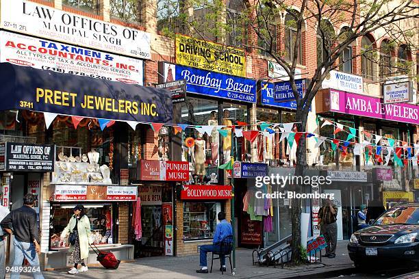 Pedestrians pass by jewelry and other ethnic stores in Jackson Heights in the Queens borough of New York, U.S., on May 7, 2008. While Manhattan may...