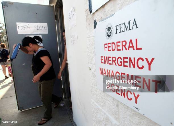 Residents leave the Federal Emergency Management Agency Disaster Relief Center after receiving assistance from several relief agencies in Ocean...