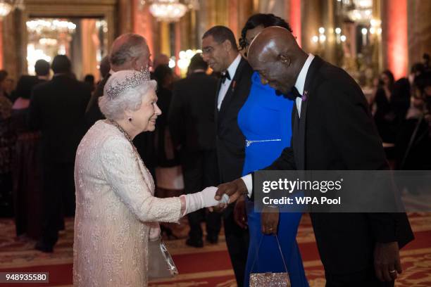 Queen Elizabeth II greets Prime Minister of Trindad and Tobago Keith Rowley in the Blue Drawing Room in the Blue Drawing Room at The Queen's Dinner...