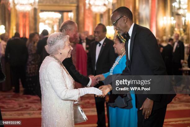 Queen Elizabeth II greets Paul Kagame, President of Rwanda in the Blue Drawing Room in the Blue Drawing Room at The Queen's Dinner during the...