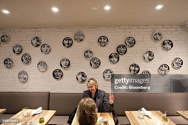 Margaret Holman, facing, talks with Susan Marx as they have lunch at Mia Dona in New York, U.S., on Monday, Feb. 25, 2008. The new restaurant is on...