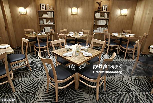 Tables await patrons inside Mia Dona in New York, U.S., on Monday, Feb. 25, 2008. The new restaurant is on 58th Street at 3rd Avenue and is the...