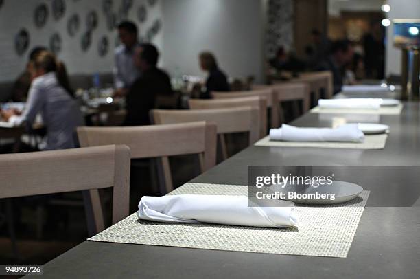 Place settings await patrons at the bar in Mia Dona in New York, U.S., on Monday, Feb. 25, 2008. The new restaurant is on 58th Street at 3rd Avenue...
