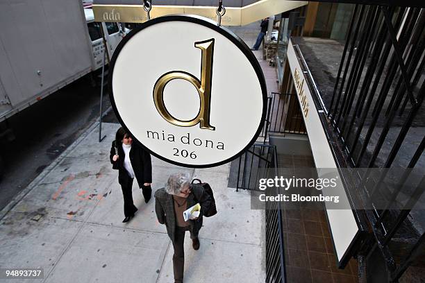 Pedestrians walk past Mia Dona in New York, U.S., on Monday, Feb. 25, 2008. The new restaurant is on 58th Street at 3rd Avenue and is the latest...