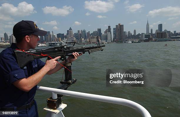 The U.S. Coast Guard Seaman, Carson Corbin mans a M60 machine gun aboard the U.S. Coast Guard Cutter Thunder Bay, August 26 in the New York waters...