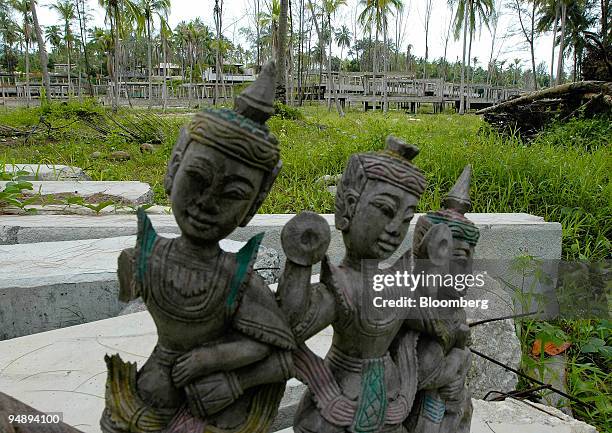 Damaged Thai wood carving rests on some toppled concrete pillars in front of Minor International Pcl's tsunami-destroyed Khao Lak Anantara Coco Palm...